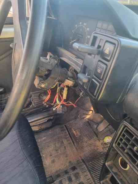 Interior do veículo Fiat Uno mostrando fios expostos e dano na ignição, indicando possíveis tentativas de arrombamento.