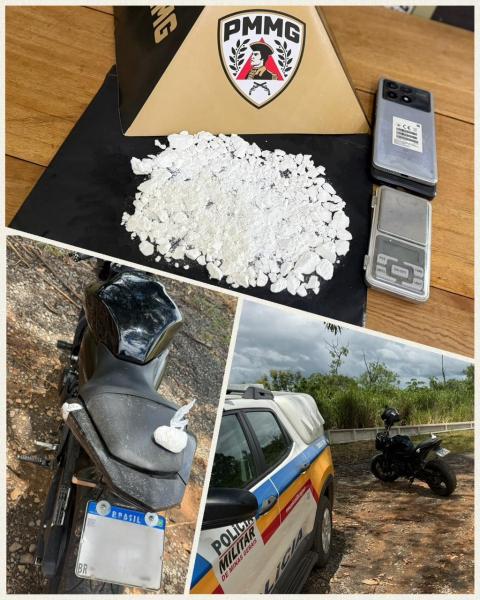 Imagem mostrando uma quantidade de substância branca, dois celulares, uma balança e uma moto em uma área rural, com um veículo da polícia militar ao fundo.